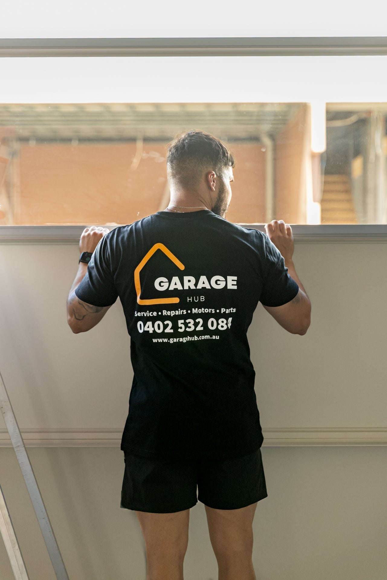 Garage hub technician servicing squeeky garage door