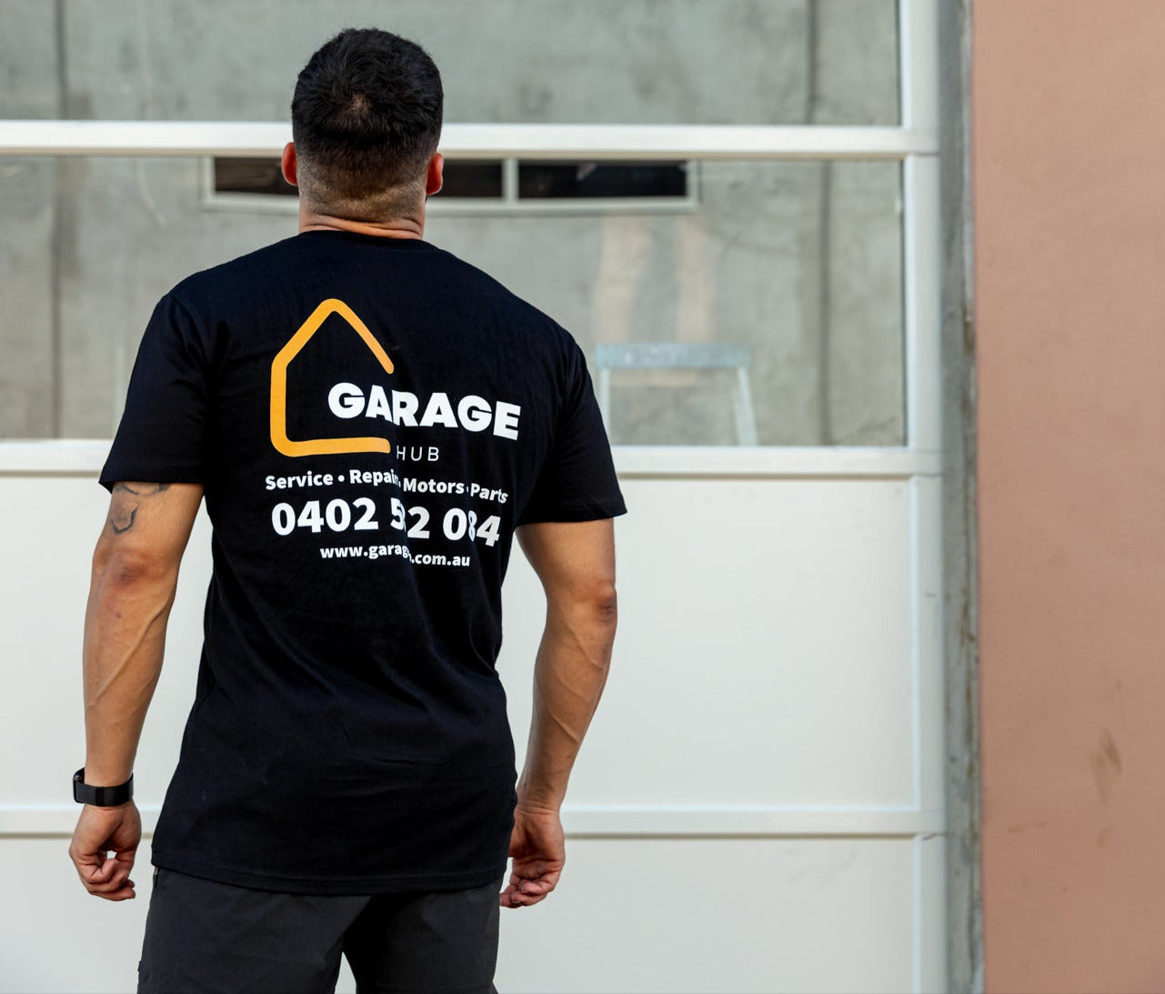 Garage hub technicians inspecting and fitting garage door panels.
