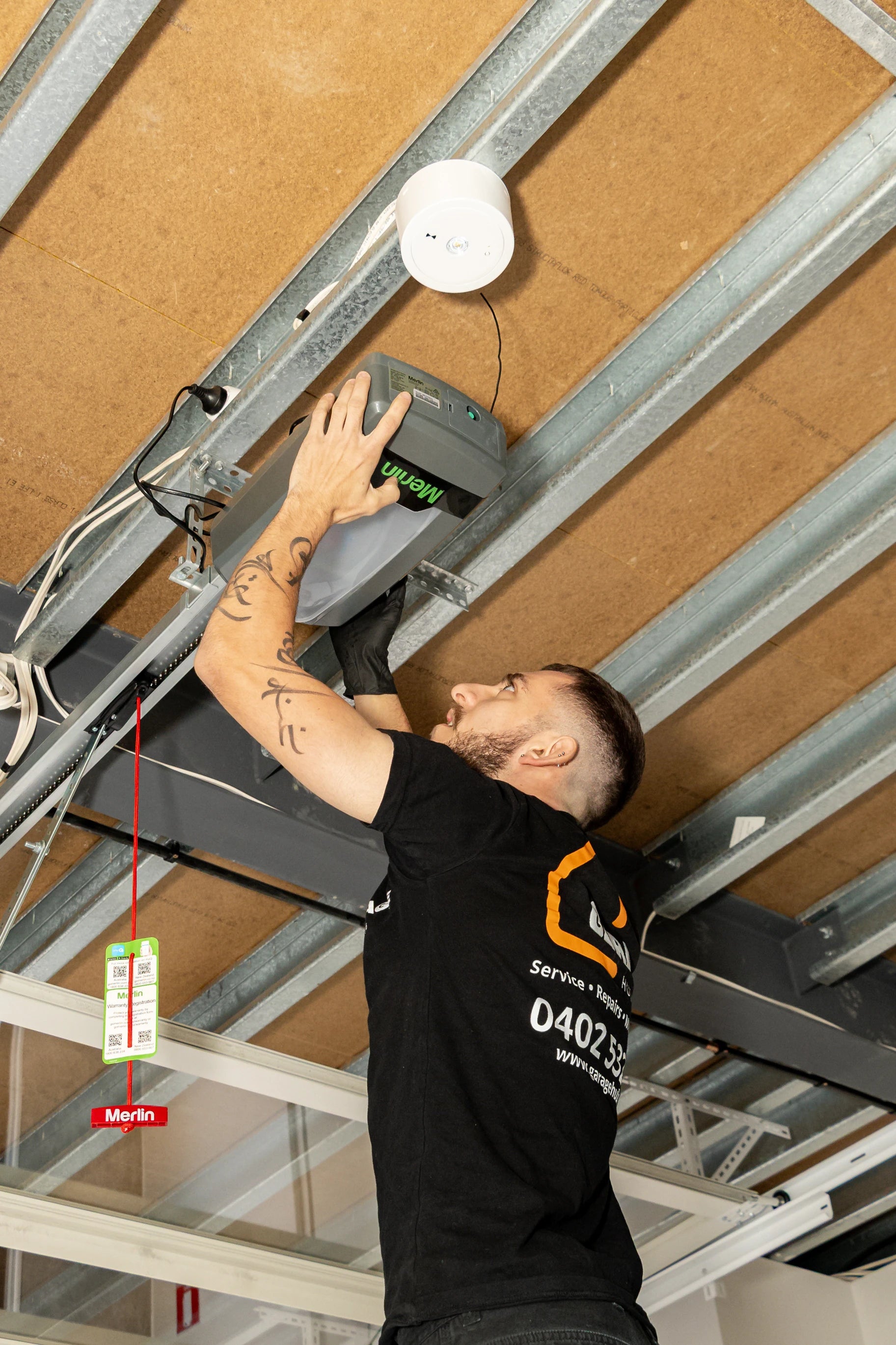 Garage hub technician installing a garage door motor.