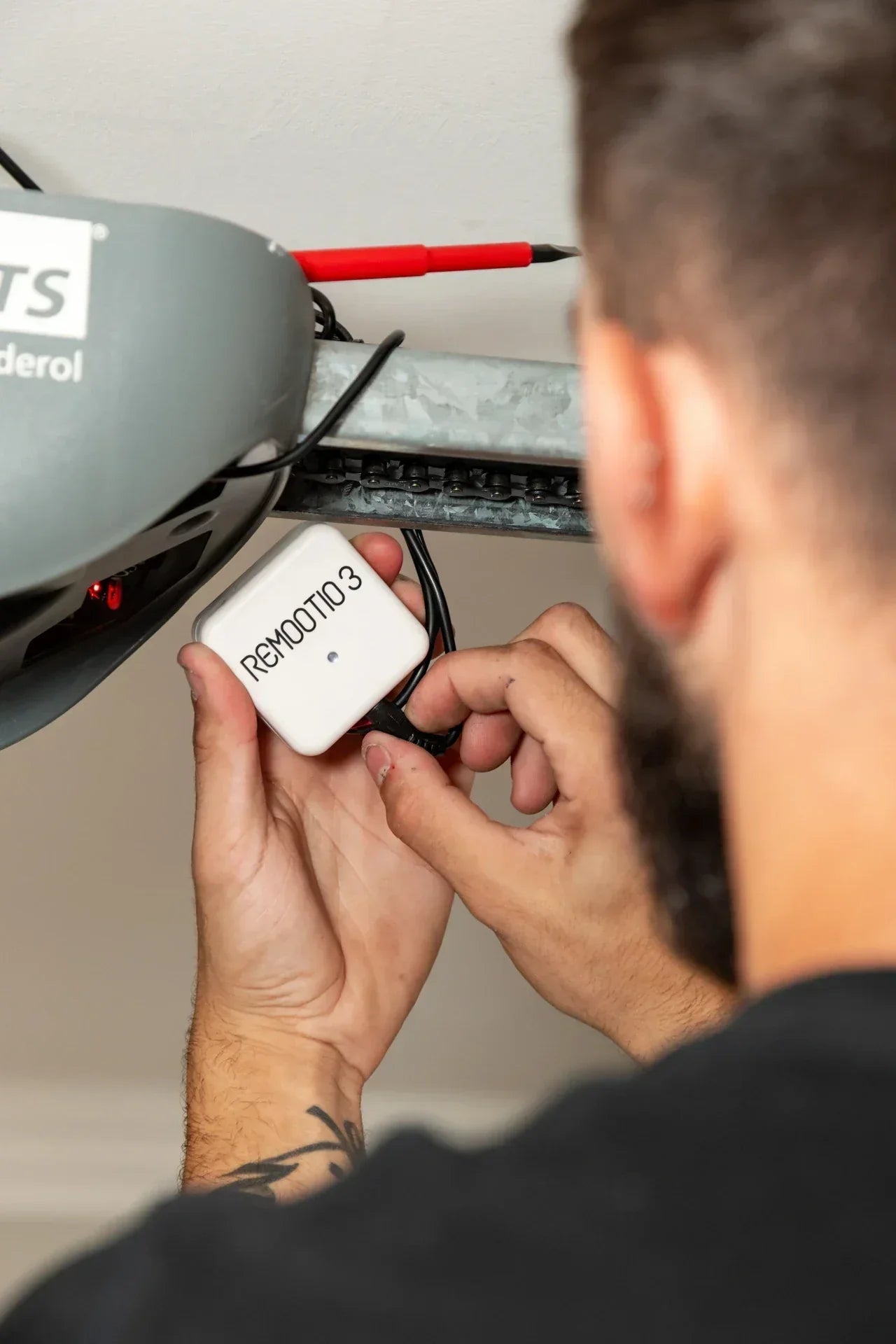 Garage Hub Technician installing smart garage door motor.