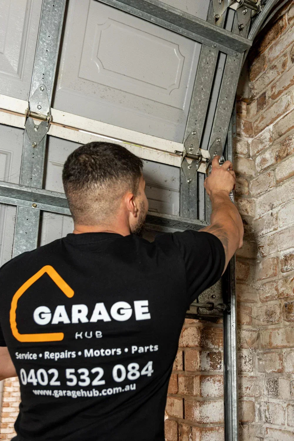 Garage door technichian servicing garage door