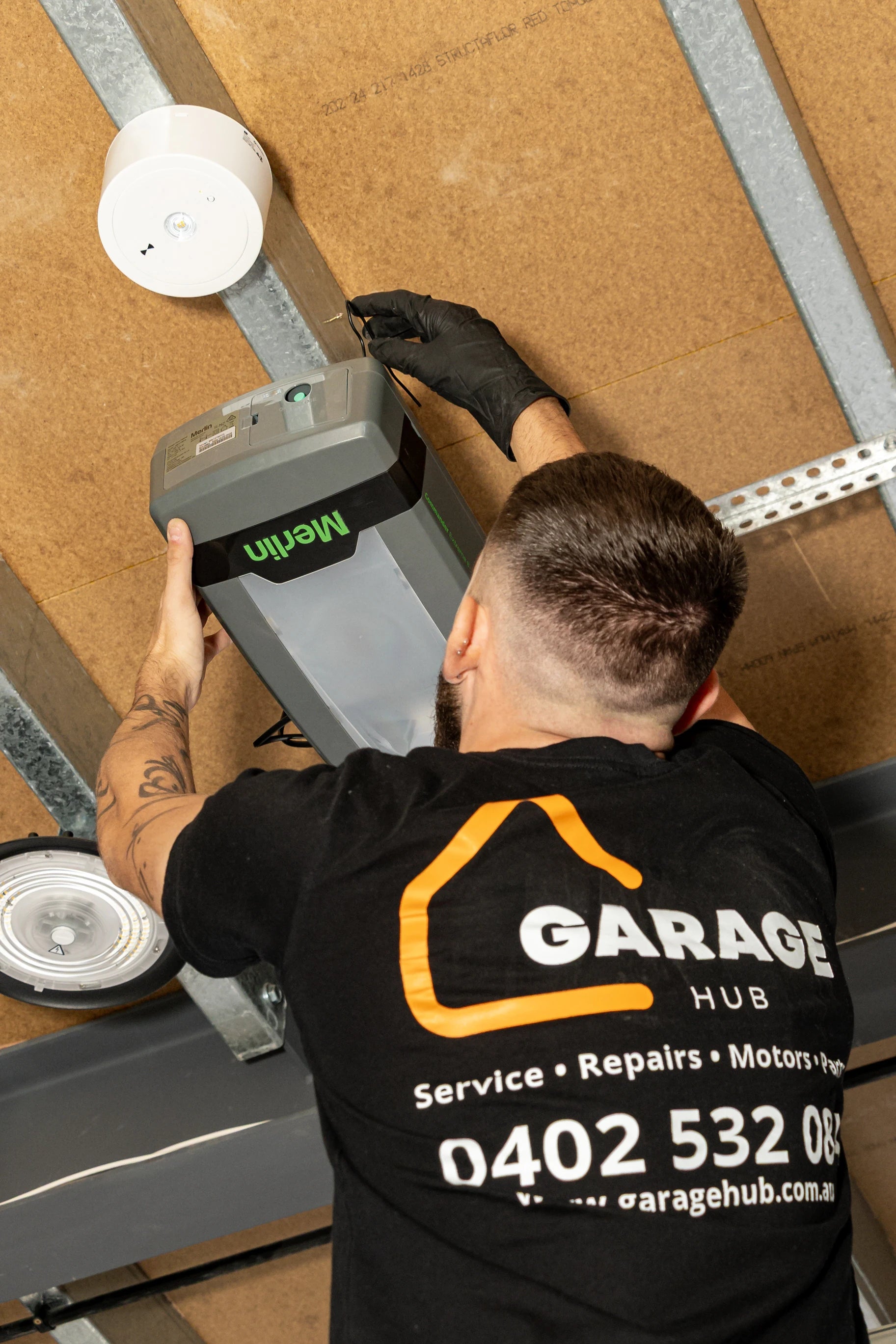 Garage hub technician installing a garage door motor.